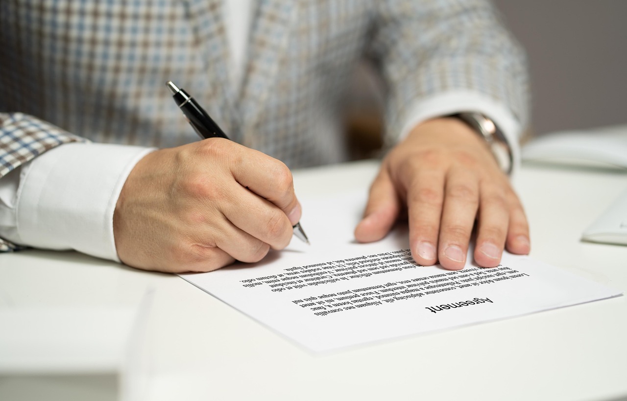 A contract being signed — the federal letters Kali files on your behalf